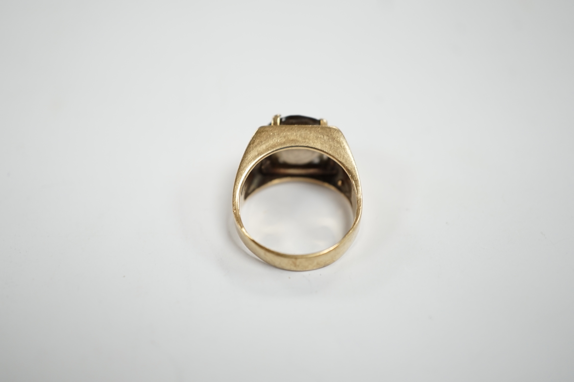 A 9ct gold and single stone oval cut smoky cut quartz set ring, size H, gross weight 4.5 grams.